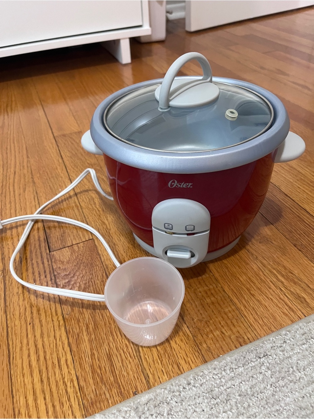 Oster Red Electric Rice Cooker with Glass Lid and Measuring Cup